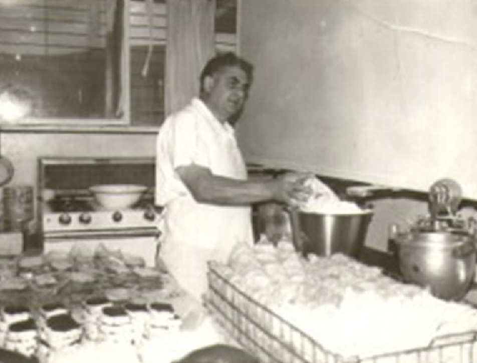 1962 Al Schullo preparing all natural foods in a kitchen, the start of a specialty foods store