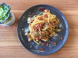 Capellini pasta with wild Mushrooms and prosciutto on dish
