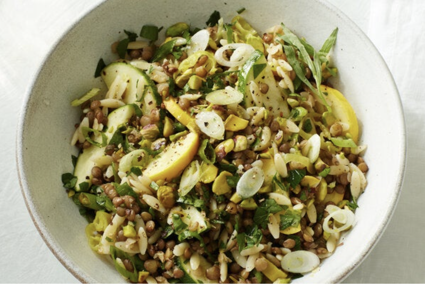 Orzo pasta salad with lentils in white dish