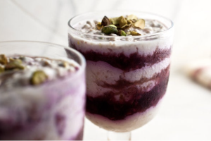 Yoghurt berry parfait with steel cut oats in glass