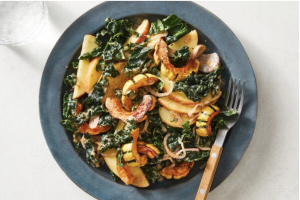 Kale and Squash salad with almond butter vinaigrette on dish