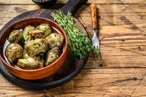 Artichoke,Hearts,Pickled,In,Olive,Oil.,Wooden,Background.,Top,View.